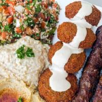 Shukran Mix Plus Platter · One skewer beef, chicken, or kabab, two kibbe, two falafel tabbouleh, hummus, baba ganoush, ...