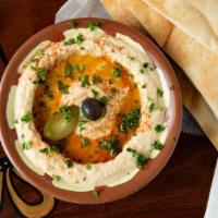 Hummus · Vegan. Pureed chick peas topped with olive oil and served with pita bread.