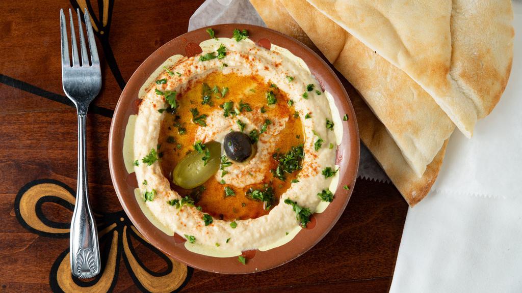 Hummus · Vegan. Pureed chick peas topped with olive oil and served with pita bread.