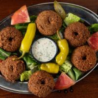 Falafel · Vegan. Six garbanzo bean patties mixed with spices, then deep fried and served with a tahini...