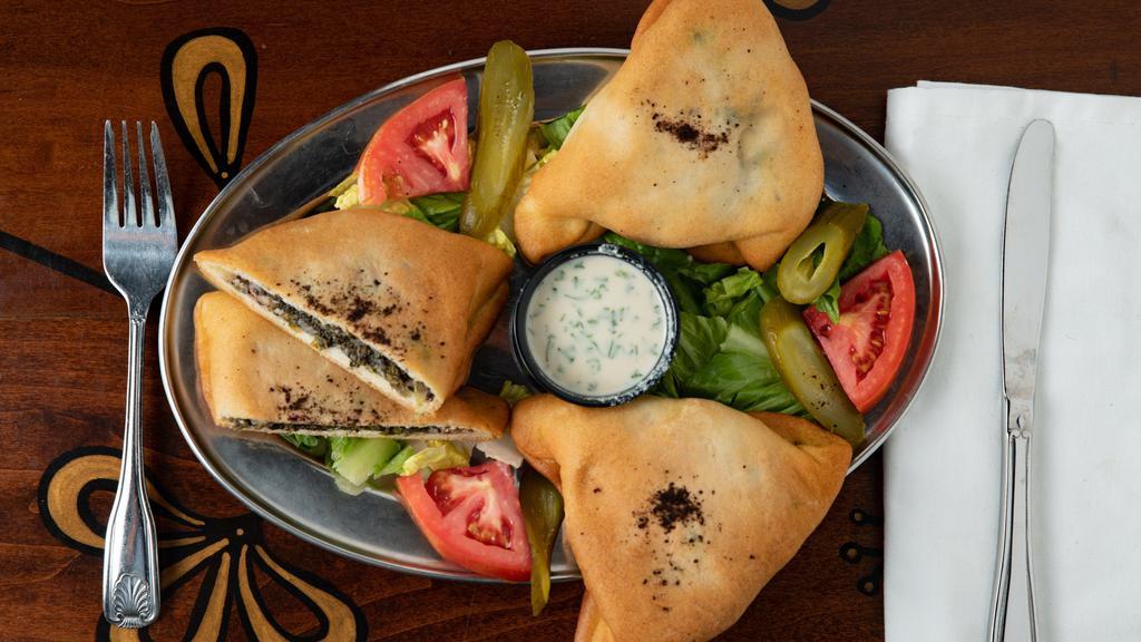 Spinach Pies · Vegan. Chopped spinach, onions, walnuts and spices wrapped in freshly baked dough.