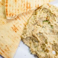Baba Ghannouj · Vegan. Pureed and roasted eggplant dip served with pita bread.
