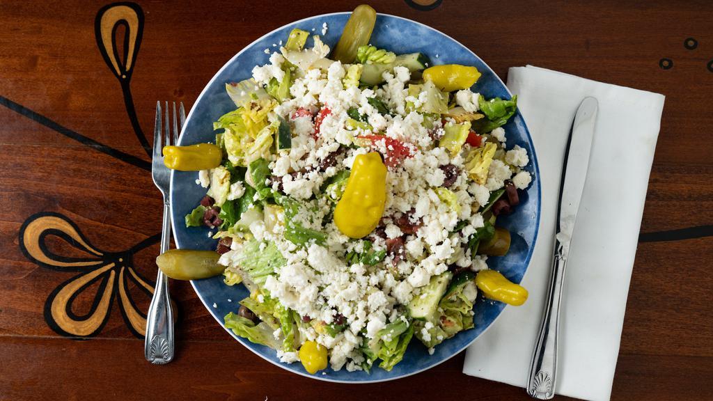 Greek Salad · The classic salad piled high with crumbled feta cheese.
