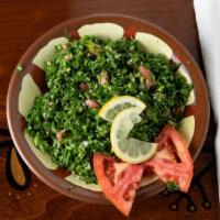 Tabouleh Salad · A traditional middle eastern salad made of parsley, cracked wheat, tomatoes, olive oil, lemo...