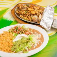 Fajitas Jalisco · Marinated tender strips of beef, chicken, and shrimp served with sauteed onions, bell pepper...