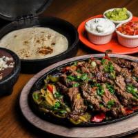 Fajita - Choose One Protein · served with grilled peppers + onions + guac + sour cream + salsa + mexican rice + beans + wa...