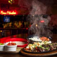 Fajita - Choose Two Proteins · served with grilled peppers + onions + guac + sour cream + salsa + mexican rice + beans + wa...
