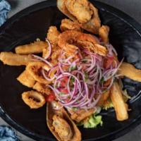 Jalea De Mariscos · Breaded crispy mixed seafood and fish served over fried yucca and salsa criolla