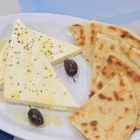 Feta Cheese Appetizer · Feta cheese garnished with olive oil and oregano. Served with Pita Bread