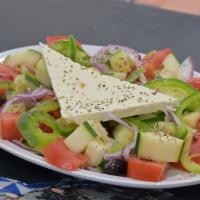 Village Greek Salad · The original Greek salad made with tomatoes, cucumbers, onions, green peppers, olives, Feta ...