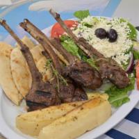 Lamb Chop Platter · Fire-grilled lamb chops marinated in fresh herbs.  Served with two sides and Pita Bread. (Pl...