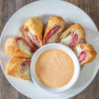 Irish Spring Rolls · Wontons stuffed with lean corned beef, cabbage and swiss cheese, served with a side of 1000 ...