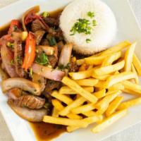 Lomo Saltado · A spiced juicy tenderloin sautéed in a wok at high heat with purple onions, green onions, to...