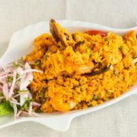 Arroz Con Mariscos · Our Peruvian version of the famous paella: seasoned rice mixed with calamari, shrimp, and mu...