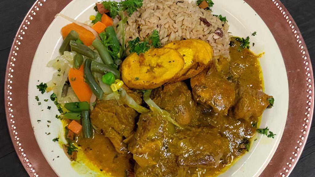 Curried Chicken · Short pieces of chicken cut up and stewed in rich Jamaican curry sauce. Served with rice & peas, steamed vegetables.