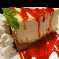 New York Cheesecake · Rich new york-style cheesecake topped with whipped cream and strawberry sauce.