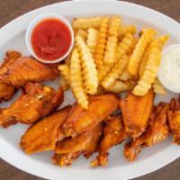 Chicken Wings · Your choice of spicy or not spicy sauce, served with carrots, celery and blue cheese.