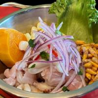 Ceviche Tradicional · Raw fish shrimp or seafood mix marinated with lime juice onions cilantro and limo chili. ser...
