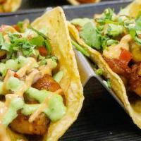 Shrimp Tacos · A set of three tacos with tiger shrimp inside a corn tortilla with special pico de gallo sau...