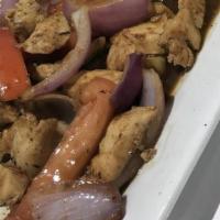 Pollo Saltado · Chicken strips sauteed with onions and tomatoes. Served with French fries and rice.