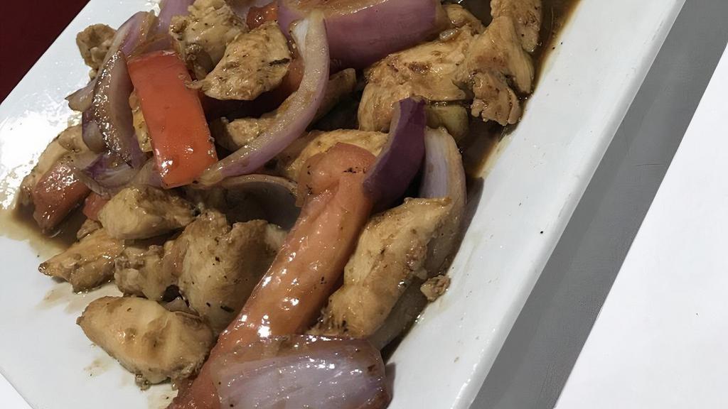 Pollo Saltado · Chicken strips sauteed with onions and tomatoes. Served with French fries and rice.