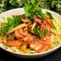 Spicy Beef Salad · Tender slices of grilled beef, tomato, cucumbers, onions, and cilantro dressed with chili li...