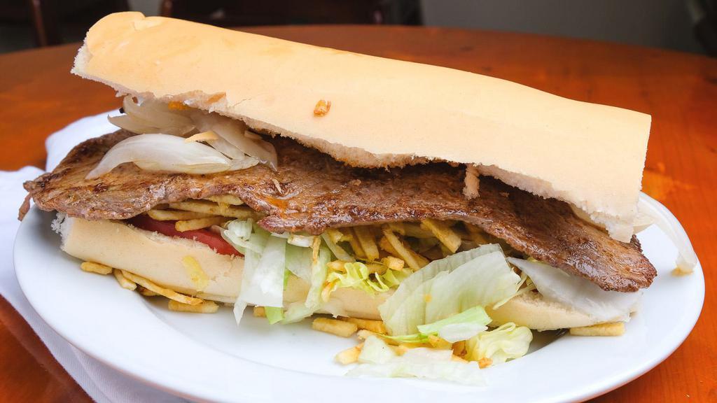 Steak Sandwich · Lettuce, tomato, onion, potato sticks and mayonnaise on pressed Cuban bread.