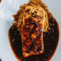 Pla Yang Prik Khing · Grilled filet of Atlantic Salmon with sauteed green beans in roasted red curry paste served ...