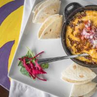 Queso Fundido · Mexican blend of cheese melted or fried with chorizo and pico de gallo.