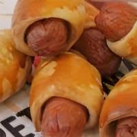 Mini Pretzel Dogs - 8 Pc · Mini hot dogs wrapped in pretzel dough.  Sauces availalble.