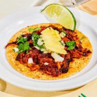 Al Pastor Taco. · Pasture-raised certified Berkshire pork, thinly sliced and marinated in a special chilies an...