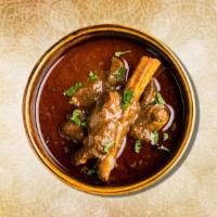 Goat Curry  · Tender goat meat cooked slowly  with tomatoes, onions, fresh herbs and Indian spices.