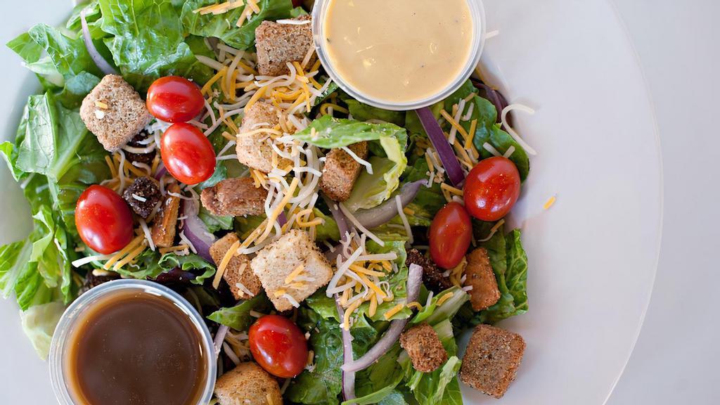 Half Garden Fresh Salad · Garden-fresh mixed greens, crispy croutons, plump tomatoes and red onions coupled with a cheddar and monterey jack cheese blend. Served with your choice of dressing.