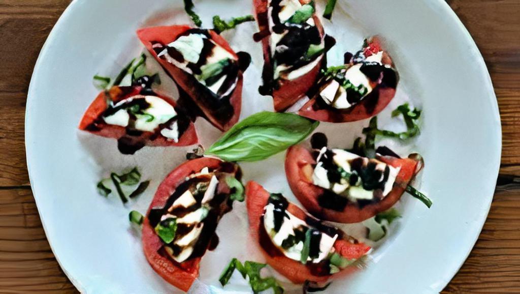 La Caprese Salad · Sliced tomatoes, fresh mozzarella, basil and balsamic glaze