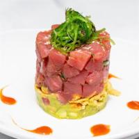 Poke Tuna Tower · Diced Ahi Tuna, Guacamole, Crispy Wonton Strips, Wakame, Sesame, Soy, Sriracha