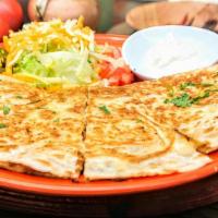 Quesadilla De La Casa · Oaxaca cheese for quesadilla, sautéed bell peppers and onions and choice of meat, in a large...