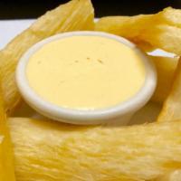 Yuquitas Fritas A La Huancaina · Fried yucca in yellow pepper cheese sauce.