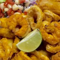 Jalea Mixta · Deep-fried fish seafood served with fried yucca onions sauce.