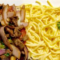 Tallarines A La Huancaina Con Lomo Saltado · Pasta in yellow chilli and cheese sauce served with fine Steak pieces sautéed with onions an...