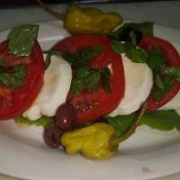 Caprese Salad · Fresh mozzarella cheese, tomatoes, and basil.