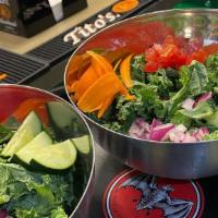 Mi Casa Salad · Kale, carrots, tomatoes, red onions, and cucumbers.