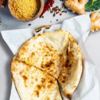 Butter Naan · Freshly baked bread in a clay oven garnished with butter.