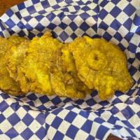 Tostones (6 Pieces) · Green plantains fried into the shape of small cookies.