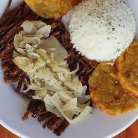 Vaca Frita · Marinated flank steak pulled but kept in steak form, seared to a crisp with citrus juices, s...