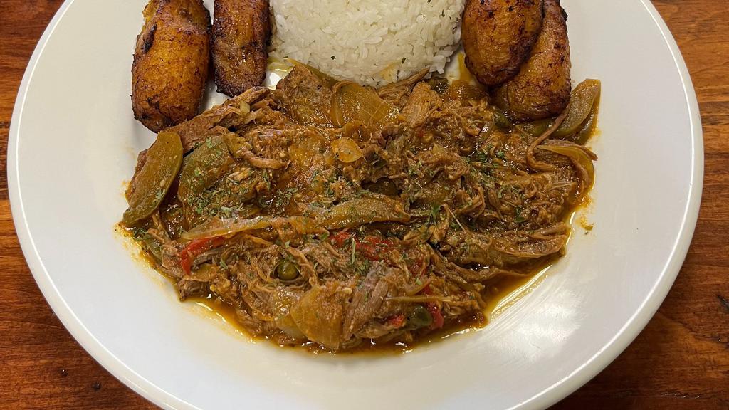 Ropa Vieja / Pulled Flank Steak · Cooked in red wine tomato sauce, onions, bell peppers, olives and spices.