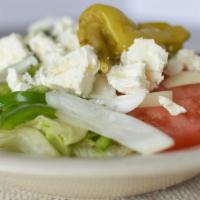 Greek Salad · Greek salad is served with cucumber, feta cheese, greek dressing, green pepper, iceberg lett...