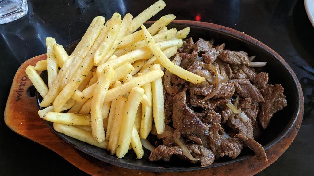 Beef Acebolada · Beef sautéed with onions and garlic served with garlic French fries.