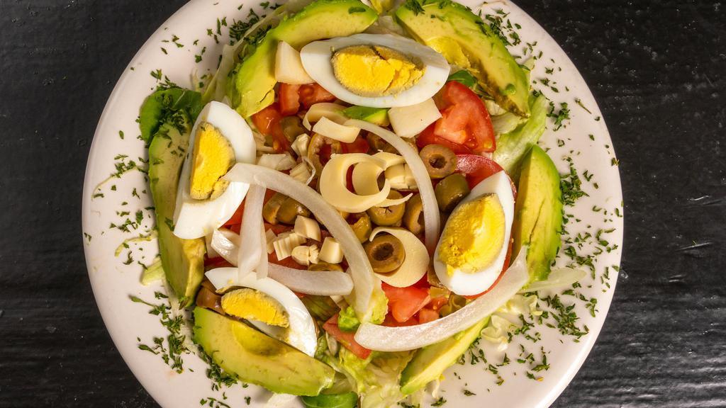 Salada Brasileira · Iceberg lettuce, tomato, heart palm, olives, egg, and onion.