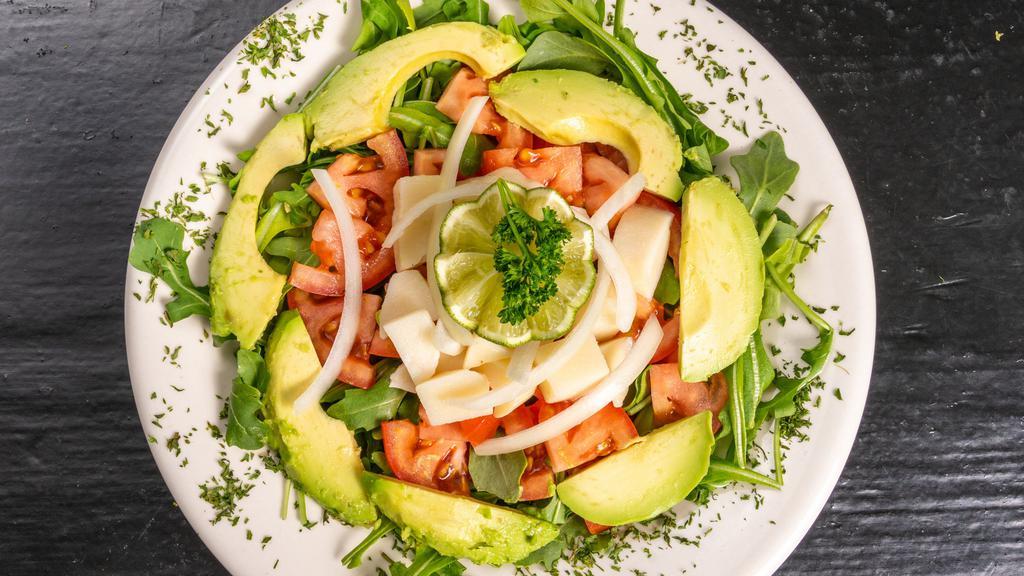Italian Salad · Arugula, tomato, onion, avocado, and heart palm.