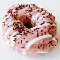 Neapolitan Doughnut · Raised doughnut topped with strawberry glaze, vanilla drizzle, and chocolate sprinkles.
